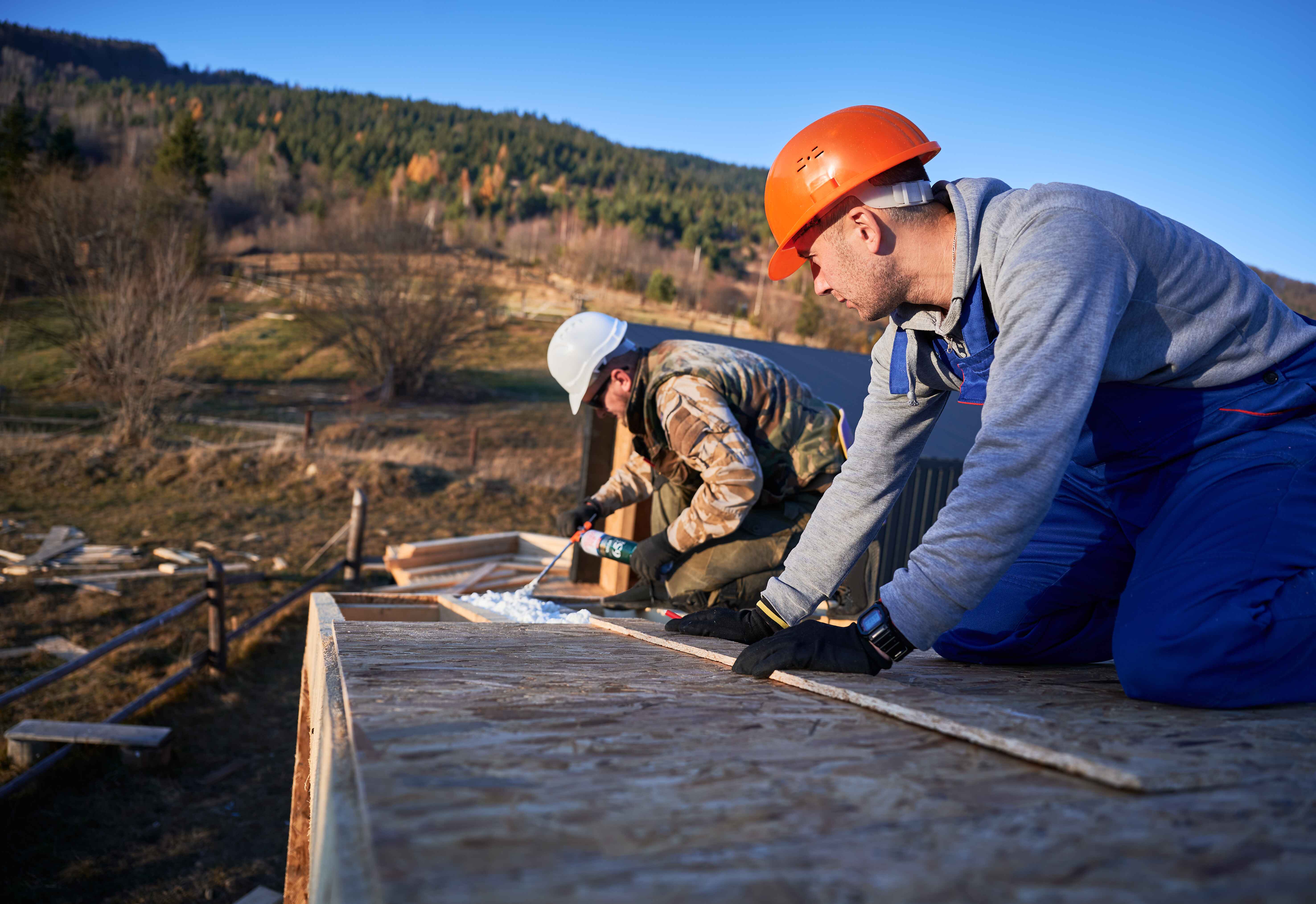 male-builder-doing-thermal-insulation-on-roof